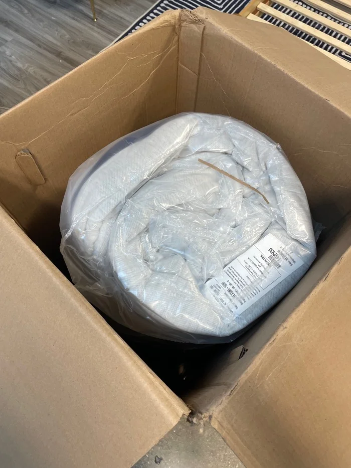 The Helix Midnight mattress rolled up in a box