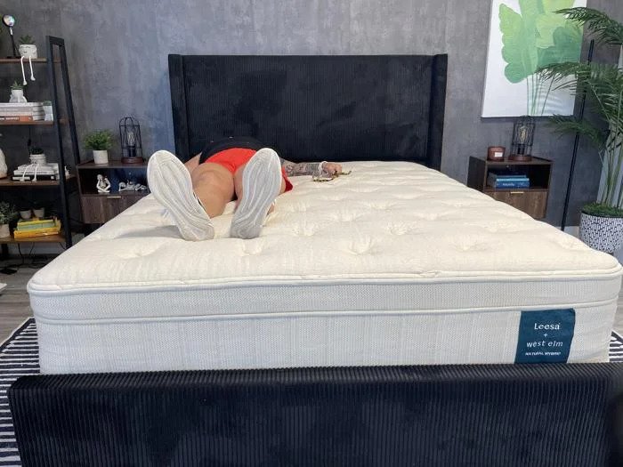 A person back-sleeping on a Leesa Natural Mattress