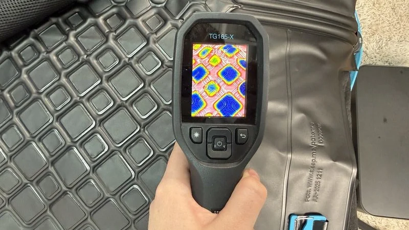 A heat gun is aimed at the surface of the Chilipad 2.0 to display how the water cools under the surface
