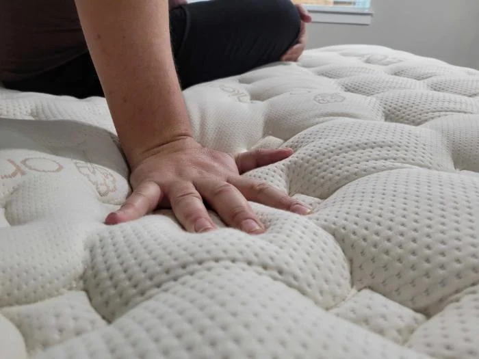 Pressing hand into Saatva Rx