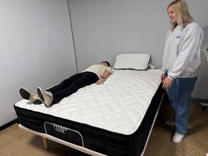 Testing motion isolation on the Titan Plus Core mattress by having two testers move around next to one another