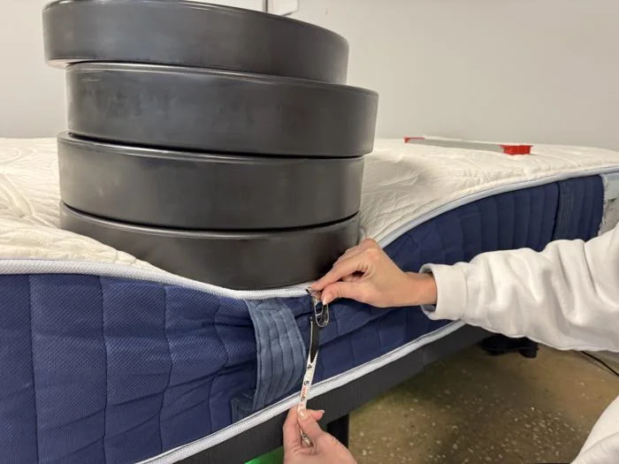 Measuring weight plates on the edge of the Glacier Original Hybrid Mattress