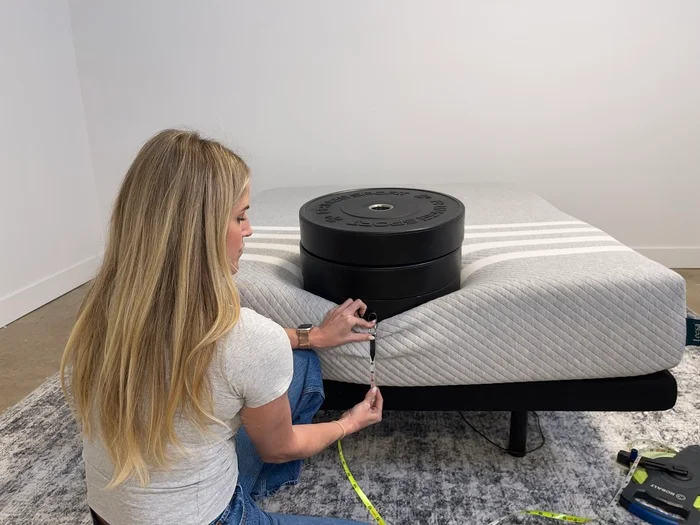 Measuring sinkage from placing weight plates on the edge of a Leesa Original Mattress