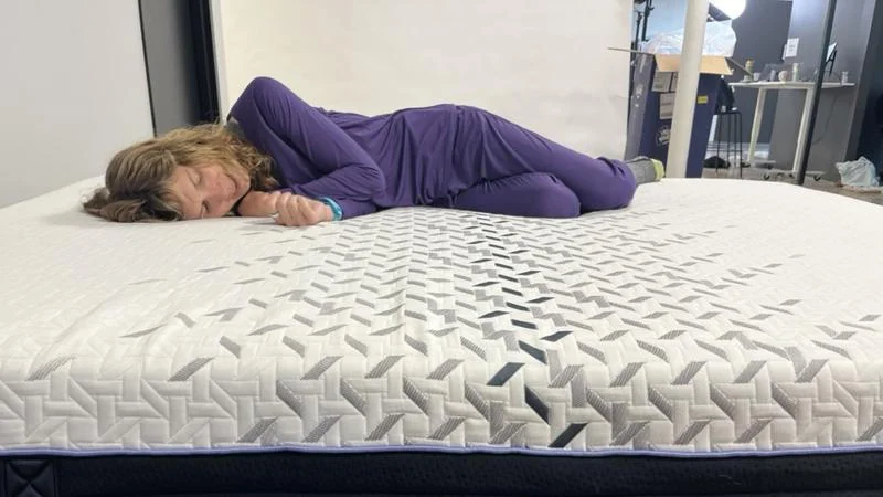 Our tester side sleeping on the Nectar Luxe Hybrid Mattress