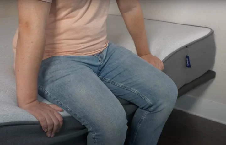 A man sits near the edge of the Casper Select mattress A man sits near the edge of the Casper Select mattress