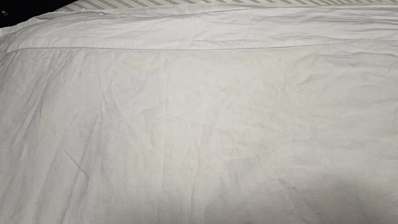 A bed made with Saatva Organic Sateen Sheets
