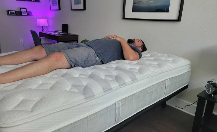 A man sleeps on his back on the Leesa Sapira Chill Hybrid