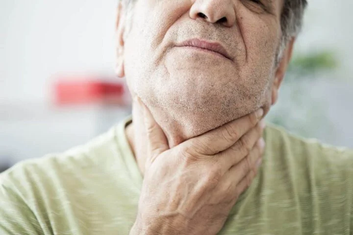 Why Do I Wake Up with a Sore Throat? a man struggles with a sore throat