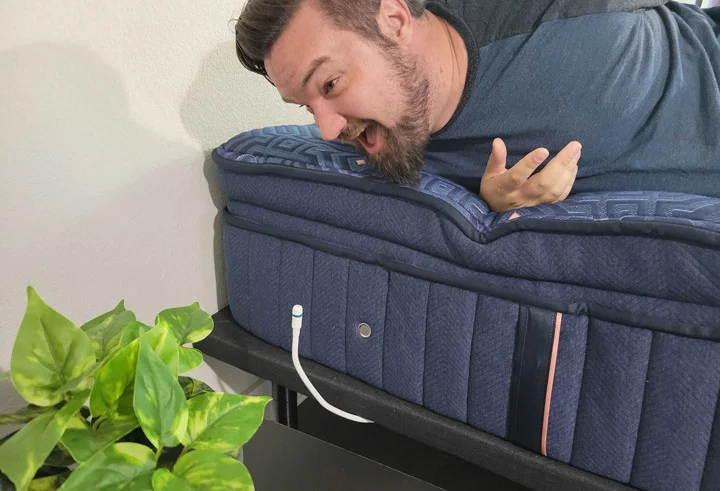 A man speaks into the microphone of the Nolah adjustable base