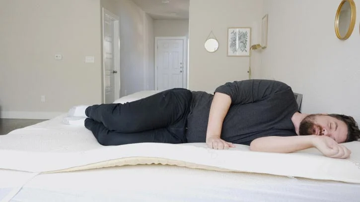 A man sleeps on his side.