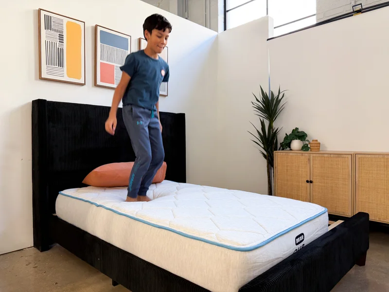 A boy jumps around on top of the Bear Cub mattress.