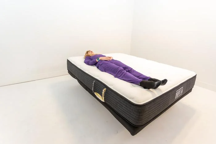 Our tester Caitlin Giddings back sleeping on the Plank Firm mattress