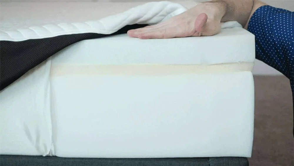 A mattress is opened to show its components.