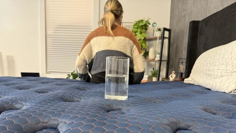 Our tester conducts a ripple test of motion isolation on the Brooklyn Bedding Aurora Luxe Mattress
