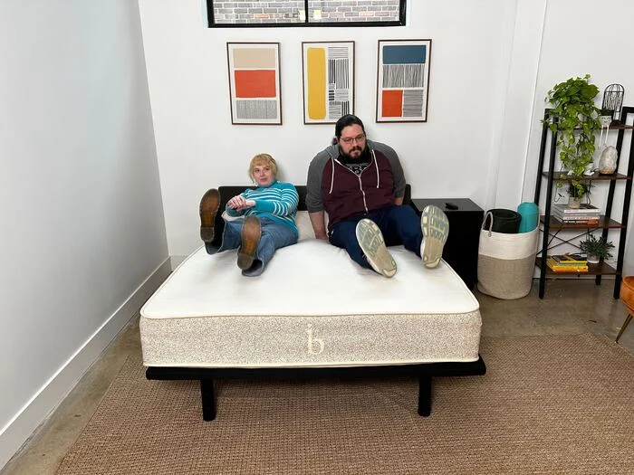 two testers sitting on top of the birch natural mattress