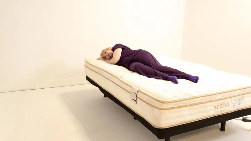 A person side sleeping on a Saatva Classic mattress