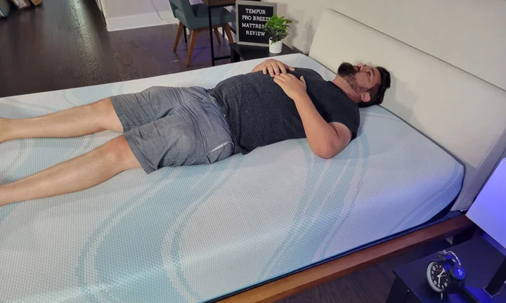 A man sleeps on his back on the TEMPUR-ProBreeze