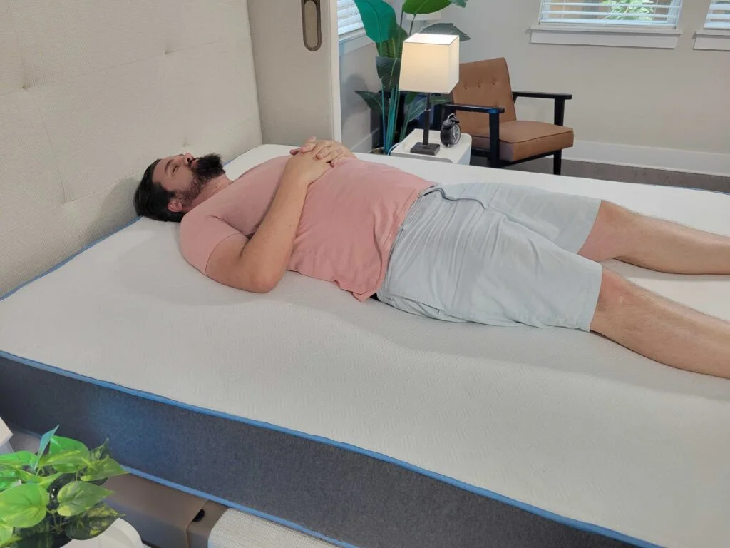 Man resting on his back on the Bear Original mattress