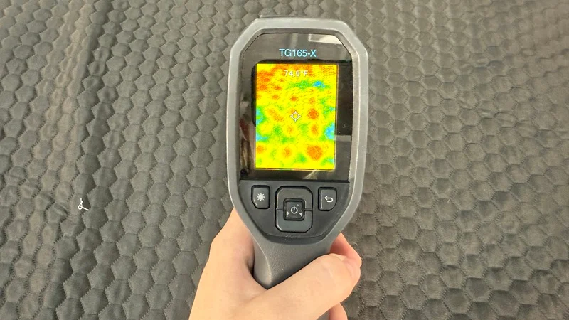 A heat gun is aimed at the surface of the Chilipad 2.0 to display how the water begins to cool the surface