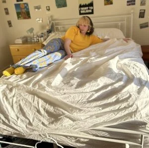 Our tester lounges on a mussed up Sleep Number True Temp Sheet Set