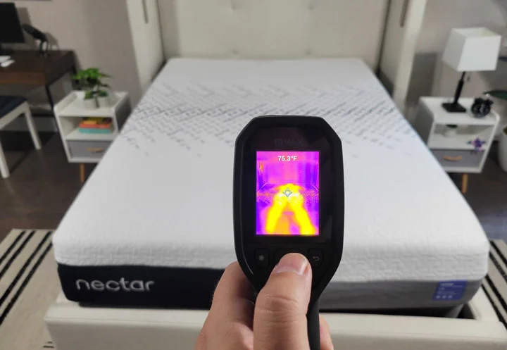 A man points a heat gun at the Nectar Luxe mattress
