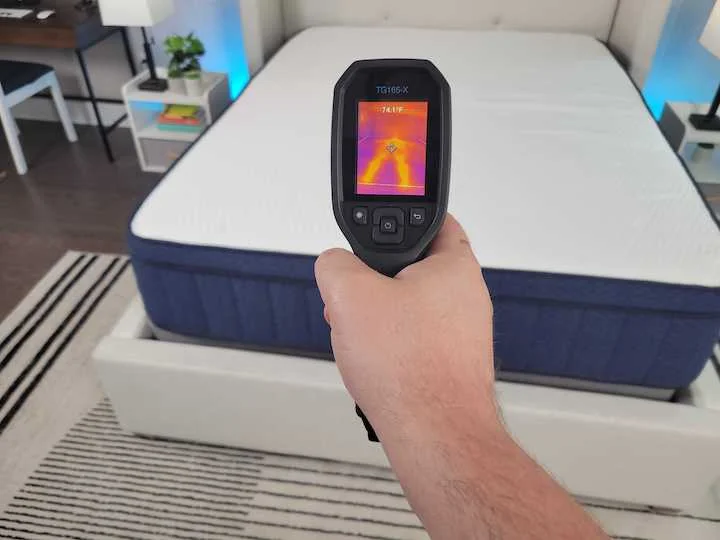 a man points a heat gun at the Aurora Luxe mattress