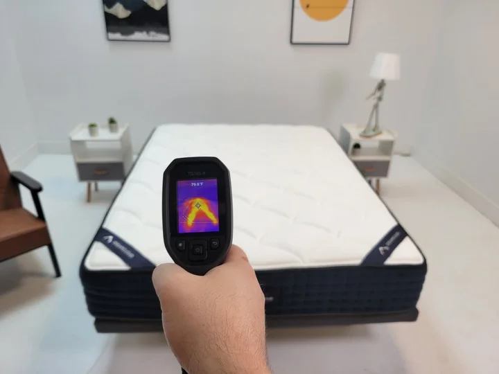 A thermal temperature readout gun pointed at the DreamCloud mattress