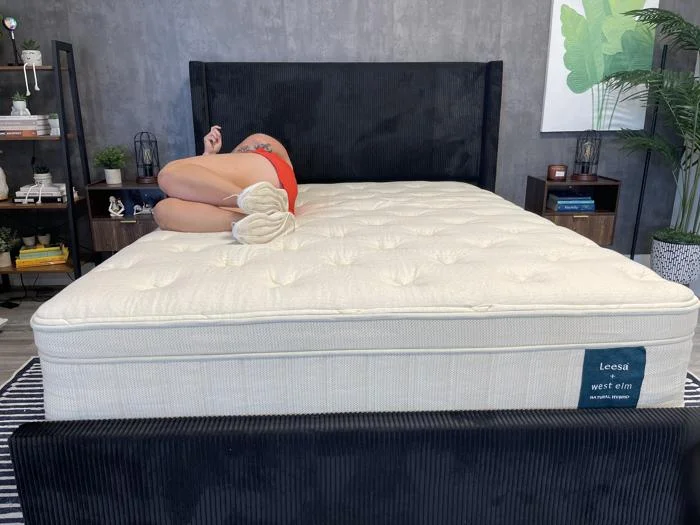 A person side-sleeping on the Leesa Natural Mattress
