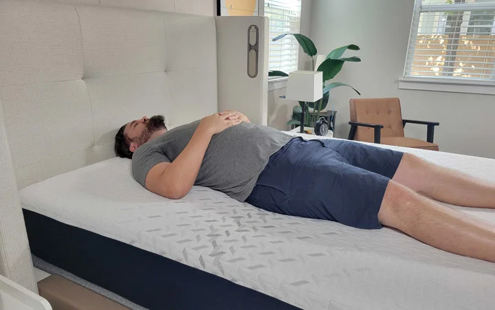 A man sleeps on his back on the Nectar Classic mattress