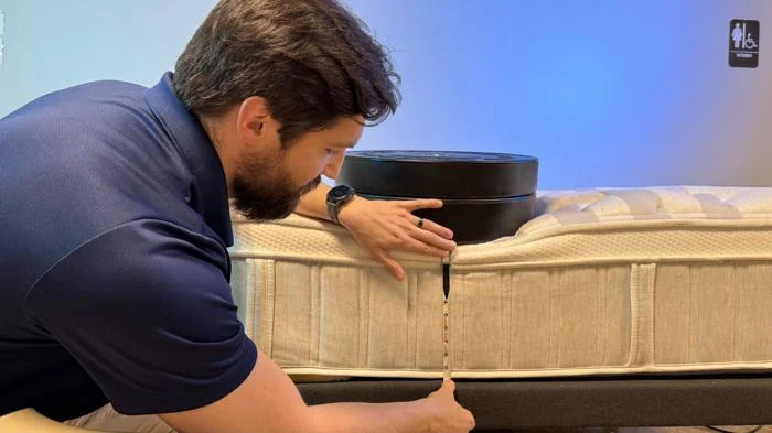 Measuring weight plates on the edge of a Leesa Sapira Chill Hybrid Mattress 1