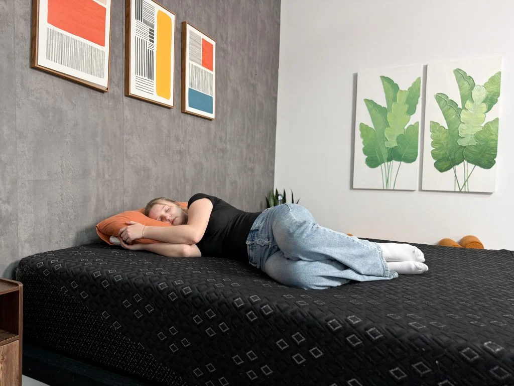 Our tester lies on her side on the Beautyrest Black Hybrid XCS