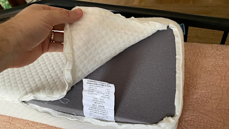 A person opens the cover of a pillow