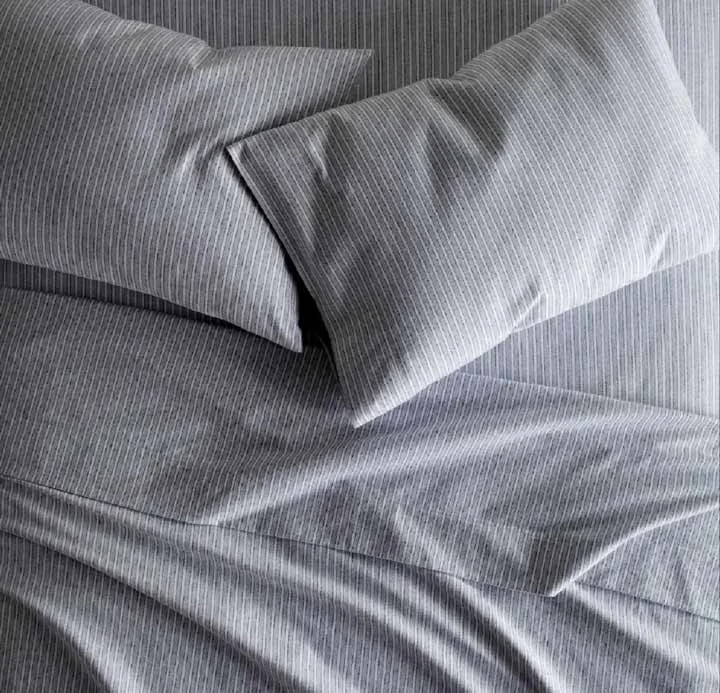 How Often Should You Buy New Sheets? A set of gray Peacock Alley Flannel sheets on a bed.