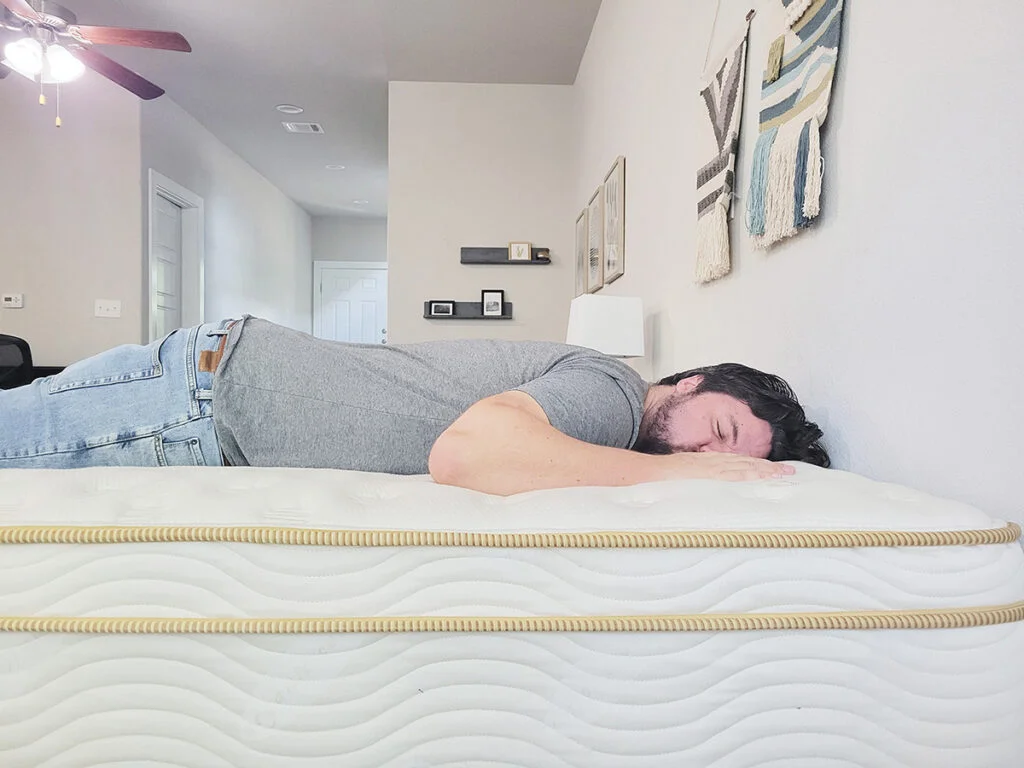 A man sleeping on his stomach on the Saatva mattress