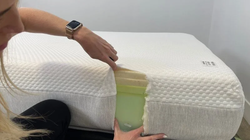 Our tester examining the interior layers of the Nolah Original mattress