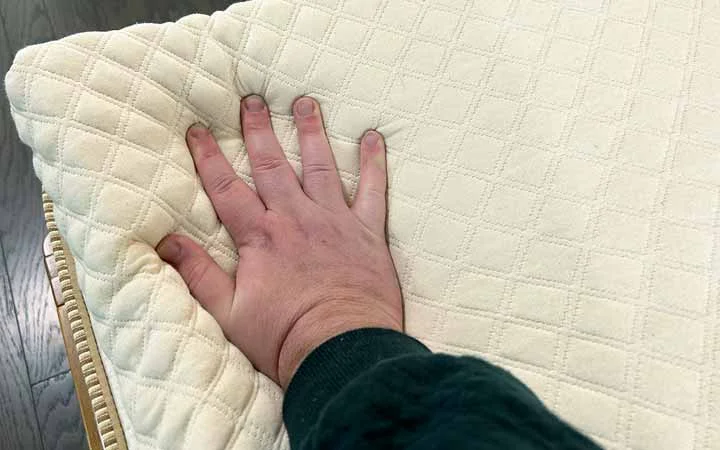 A hand presses into the Nolah Mattress Topper. A hand presses into the Nolah Mattress Topper.