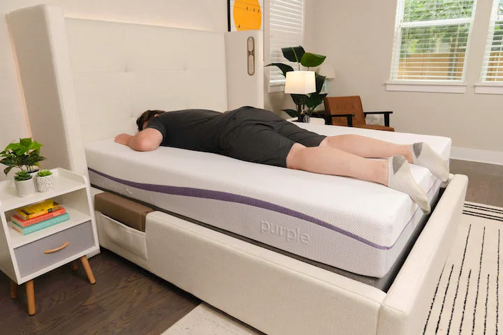 a man sleeps on his stomach on the Purple Original mattress