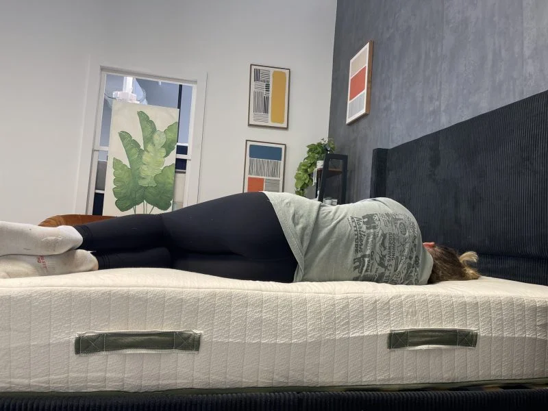 A tester lays on her side on the Avocado Eco Organic