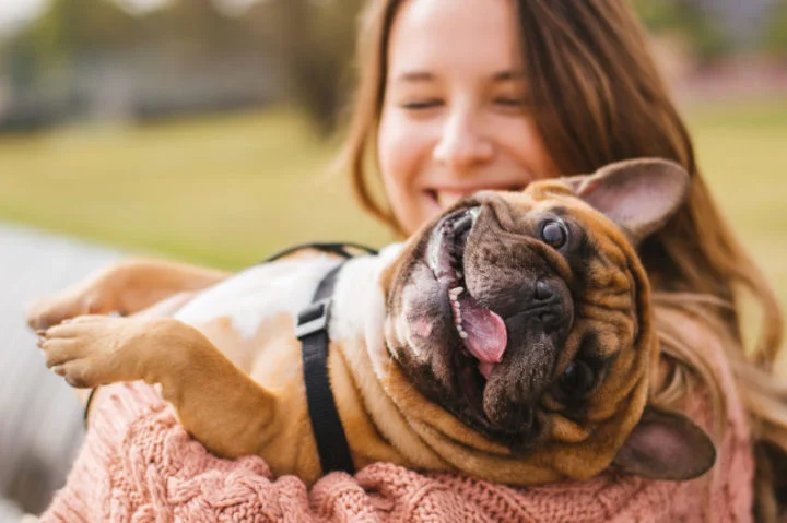 Woman holding dog Woman holding dog