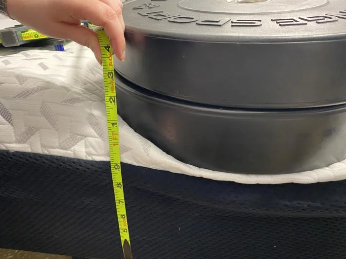 Measuring the deflection of weight plates on the edge of the Nectar Premier Memory Foam