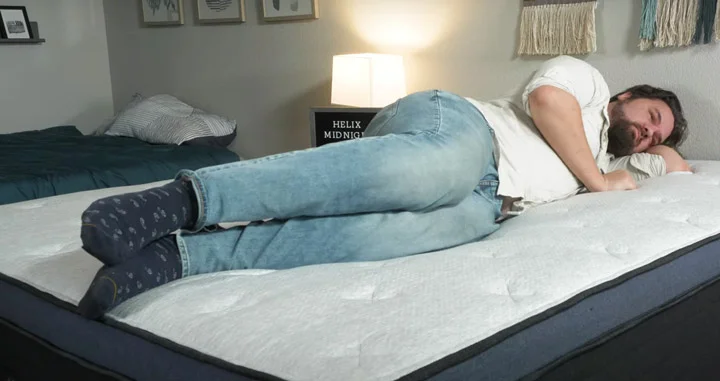 Should You Sleep With Socks On? A man sleeps on his side with socks on