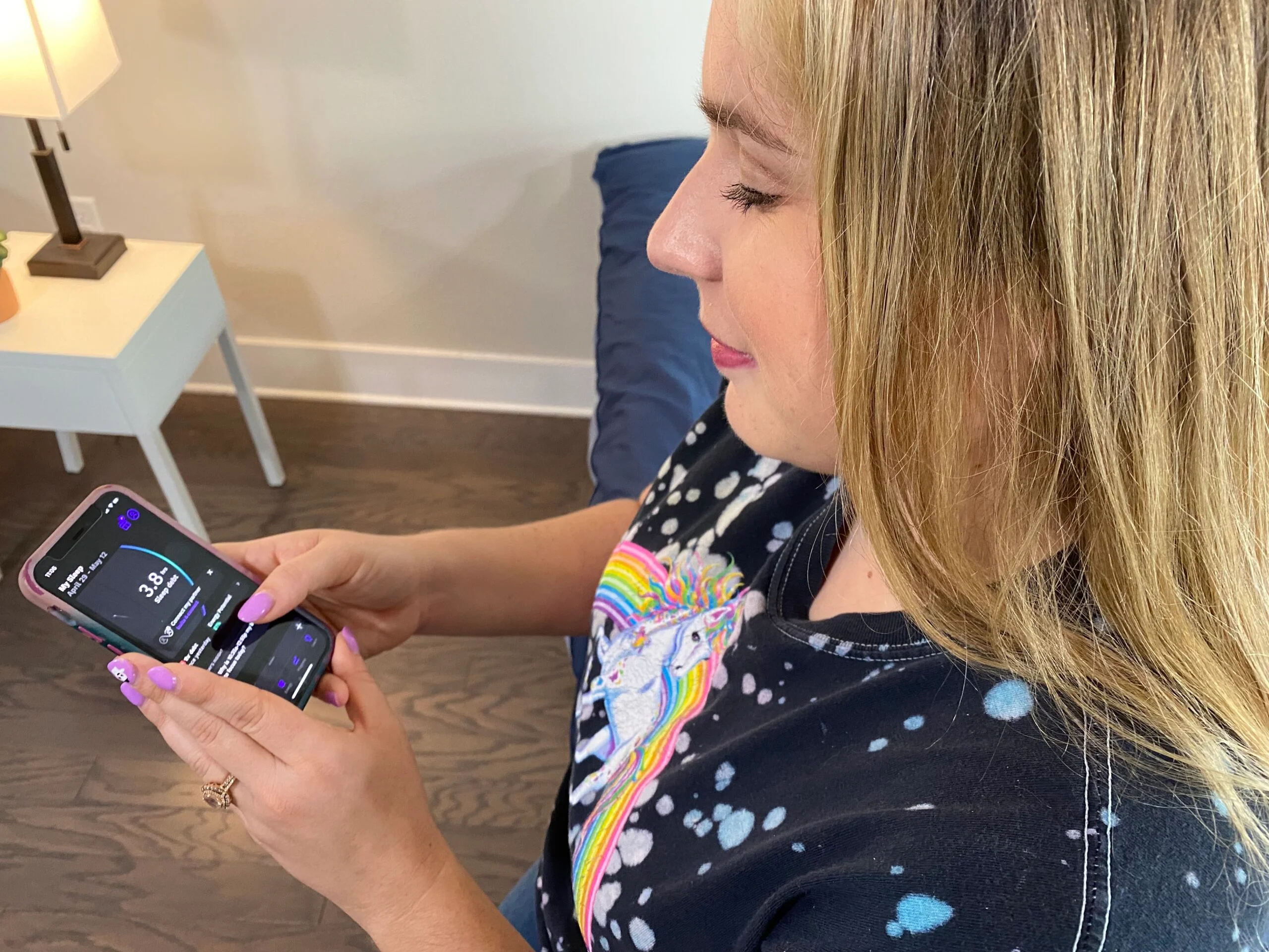 A woman uses the RISE app on her phone A woman uses the RISE app on her phone