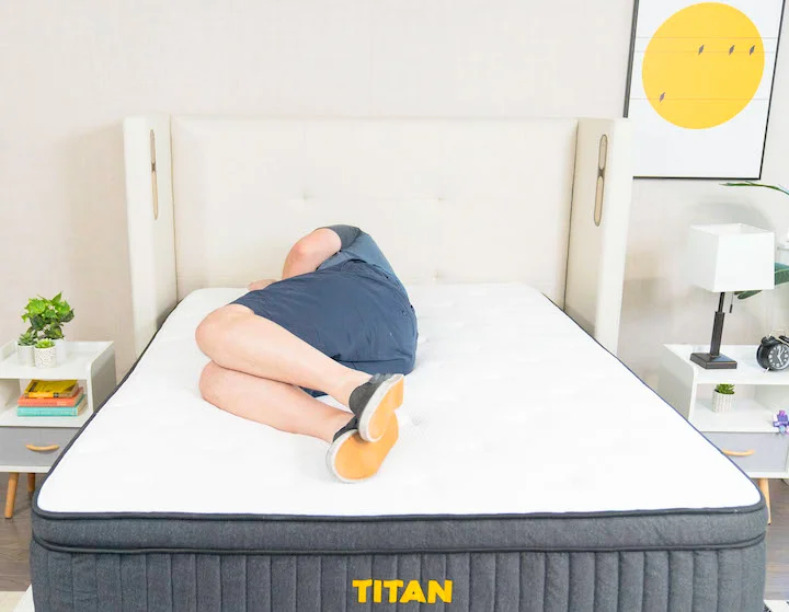 a man sleeps on his side on the Titan Plus mattress