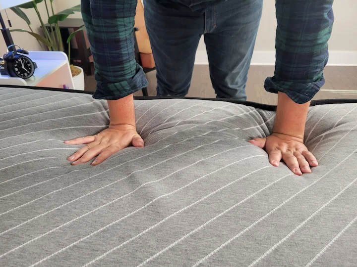 A man presses into the top layer of the Siena Premier mattress
