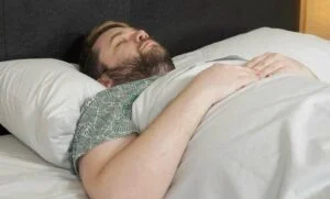 L.L. Bean Egyptian Cotton Sheets Back Sleeping A man sleeps on his back with the L.L. Bean Egyptian Cotton Sheets