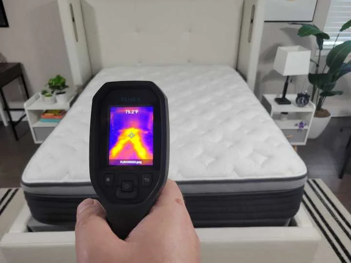 a man points a heat gun at the Helix Plus Luxe to test its cooling capabilities