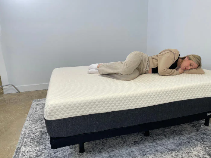 Our tester side-sleeping on the Nolah Signature Mattress