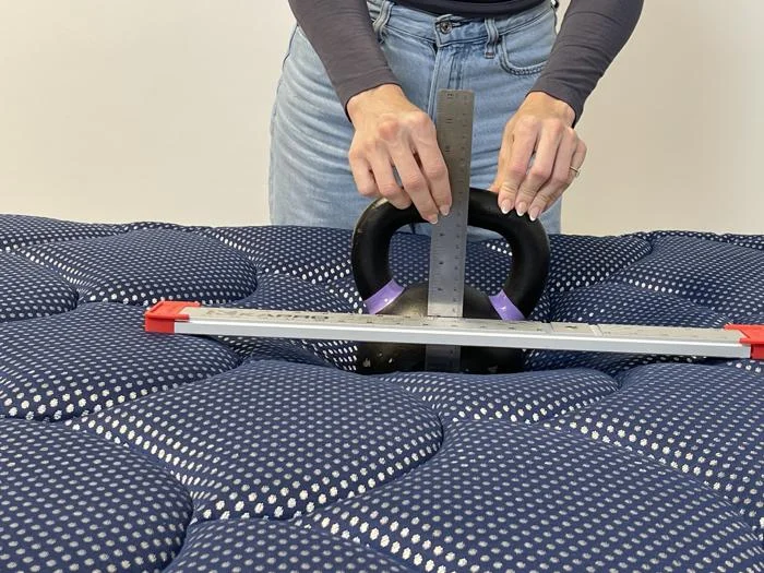 Our tester does a sinkage test on the DreamCloud Luxe Hybrid
