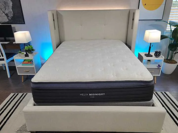 the Helix Midnight Luxe mattress sits on a bed frame in a bedroom