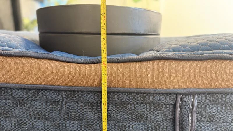 Measuring the sinkage from weight plates along the edge of the Brooklyn Bedding Aurora Luxe Mattress